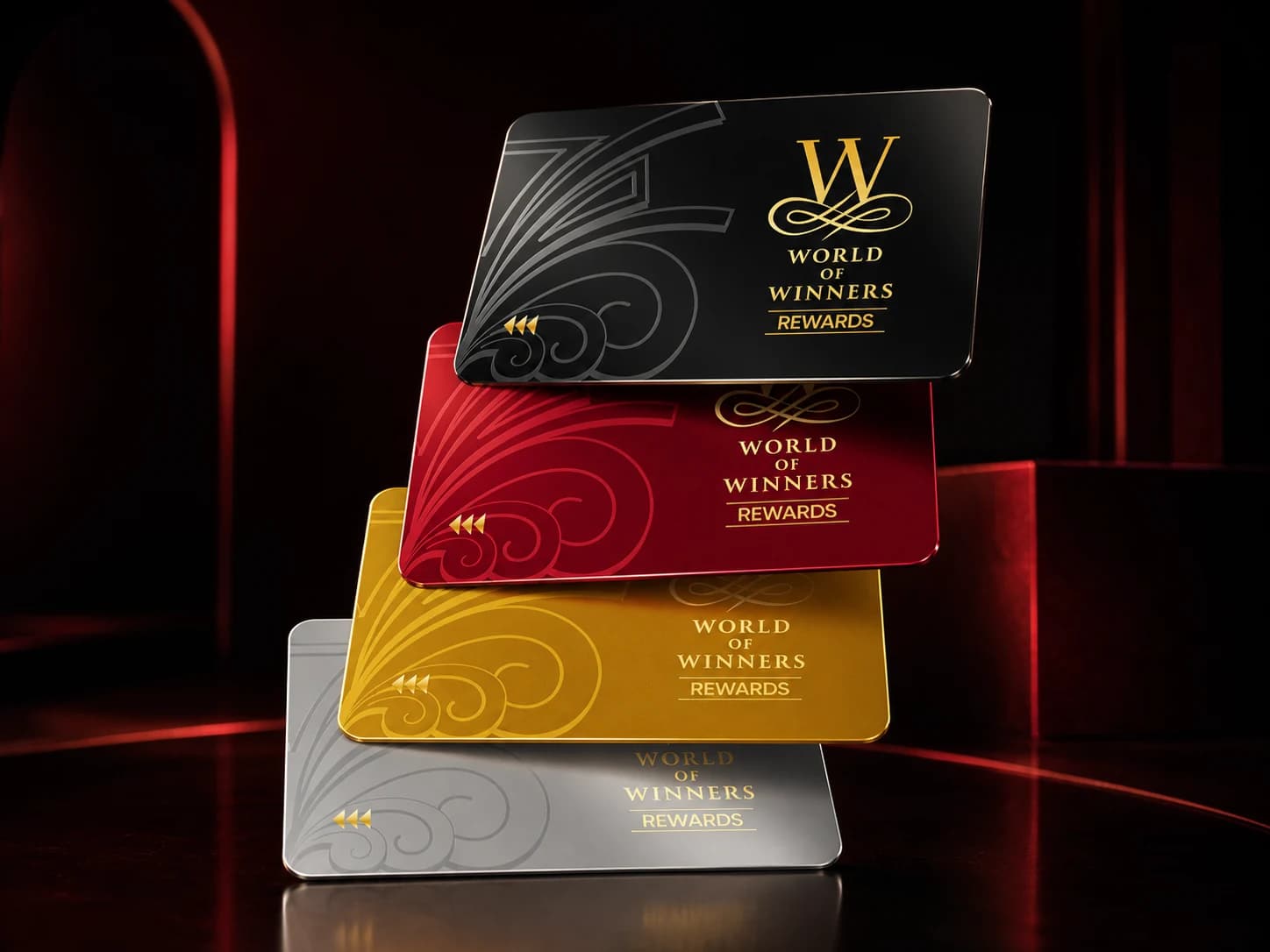 Silver, Gold, Ruby, and Black World of Winners membership cards in a sculptural arrangement